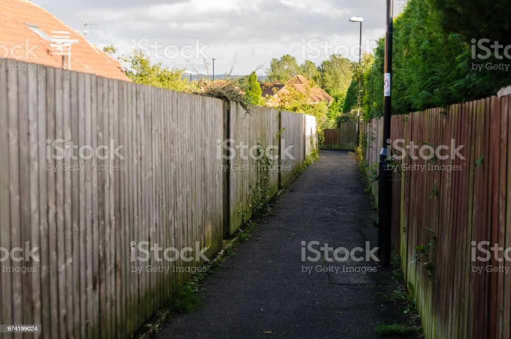 alleyway-at-the-rear-of-a-number-of-houses-with-wooden-fences-picture-id974199024 alleyway-at-the-rear-of-a-number-of-houses-with-wooden-fences-picture-id974199024